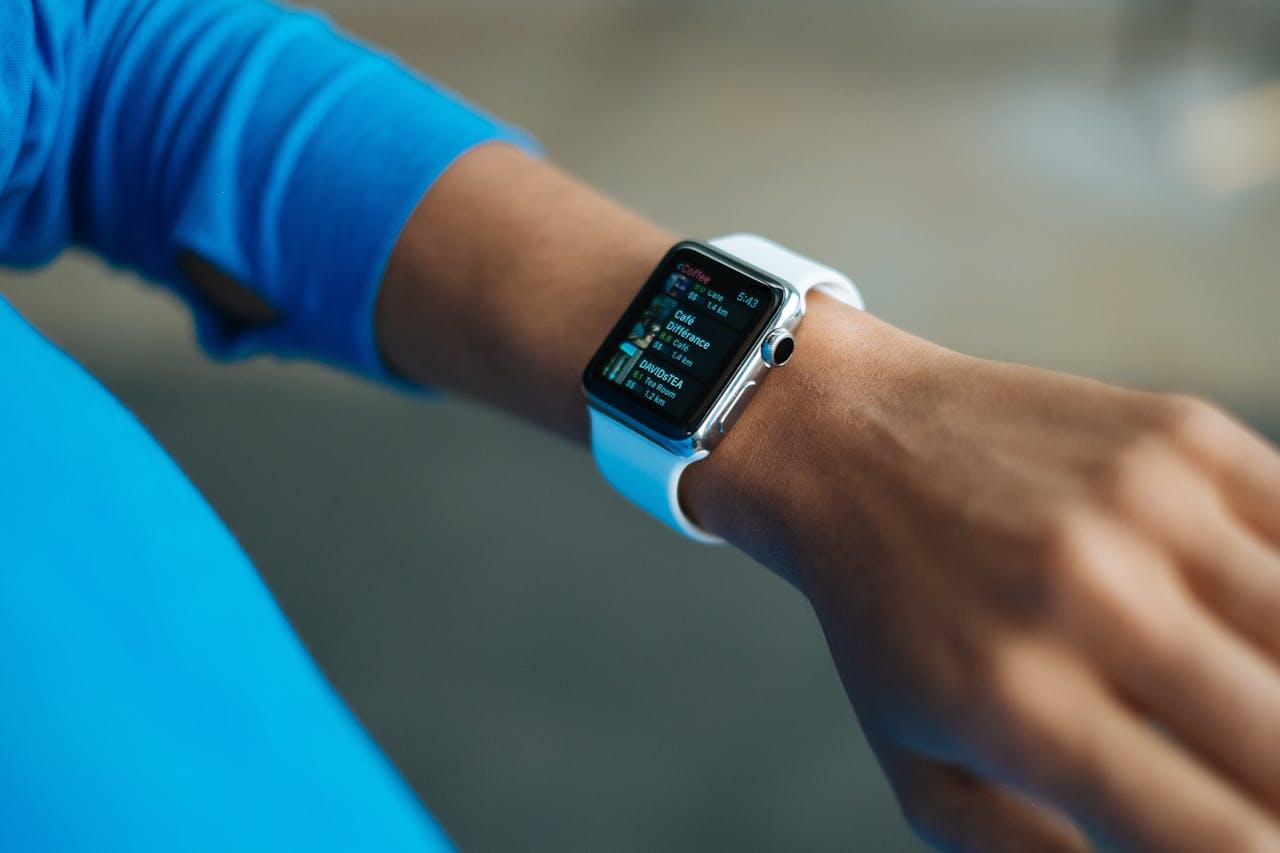 Focus on a smartwatch worn on an adults wrist, showcasing its digital display.